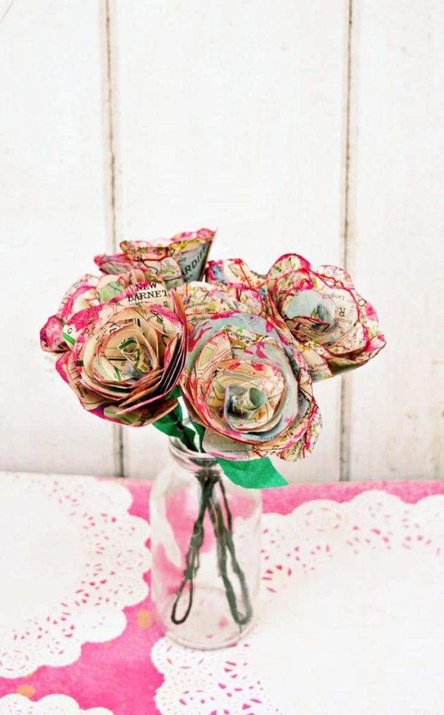 paper roses made from maps in a vase