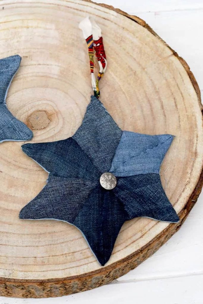 single denim patchwork quilted star laying on a wood slice