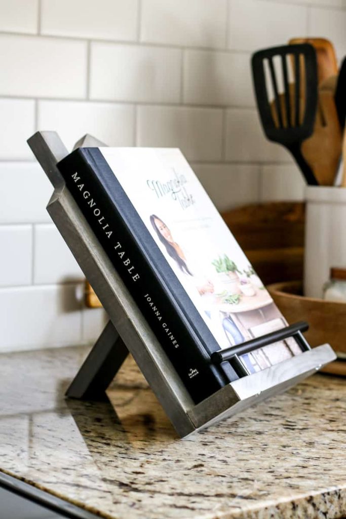 Closeup of DIY cookbook stand with cookbook sitting on the kitchen counter.