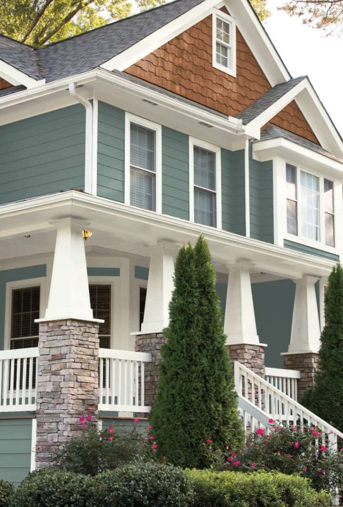 Exterior of house painted with In the Moment Behr paint color and white trim color.