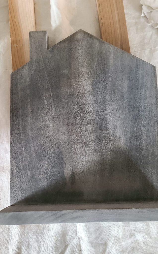 Close up of gray washed wood finish on wood cookbook stand.