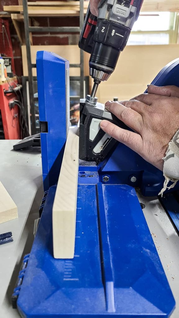 Image of man making pocket holes in a board using a pocket hole jig.