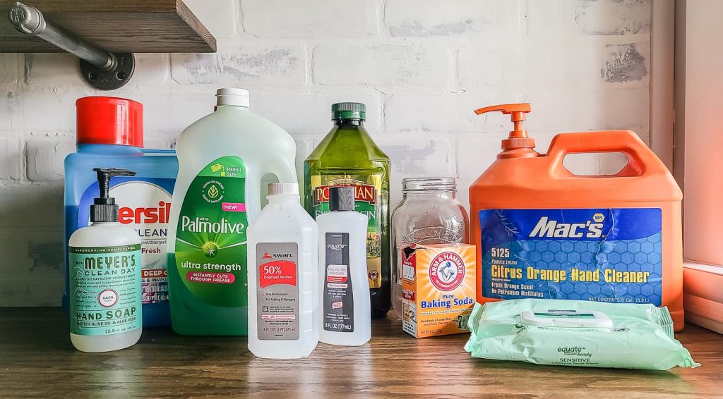 Collection of different cleaning products sitting on a wood counter top