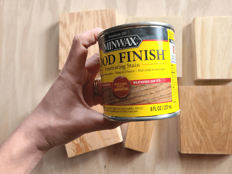 weathered oak wood stain can in woman's hand