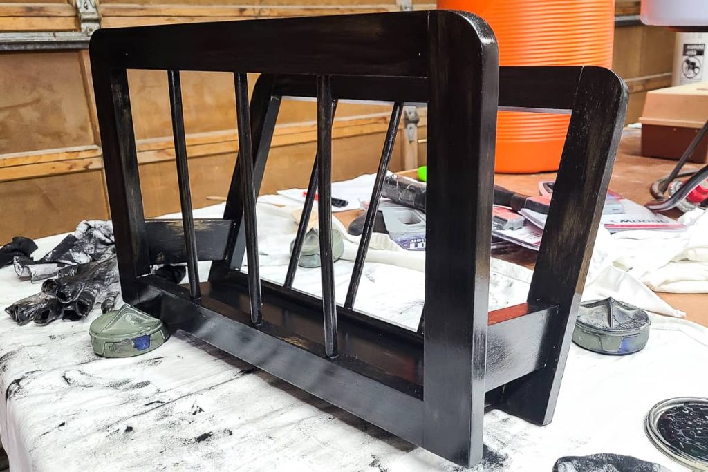 magazine rack with dark colored stain applied.