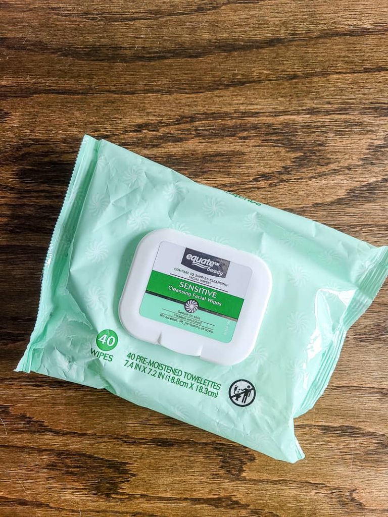 package of equate sensitive cleansing facial wipes sitting on wood counter top used to get wood stain off skin