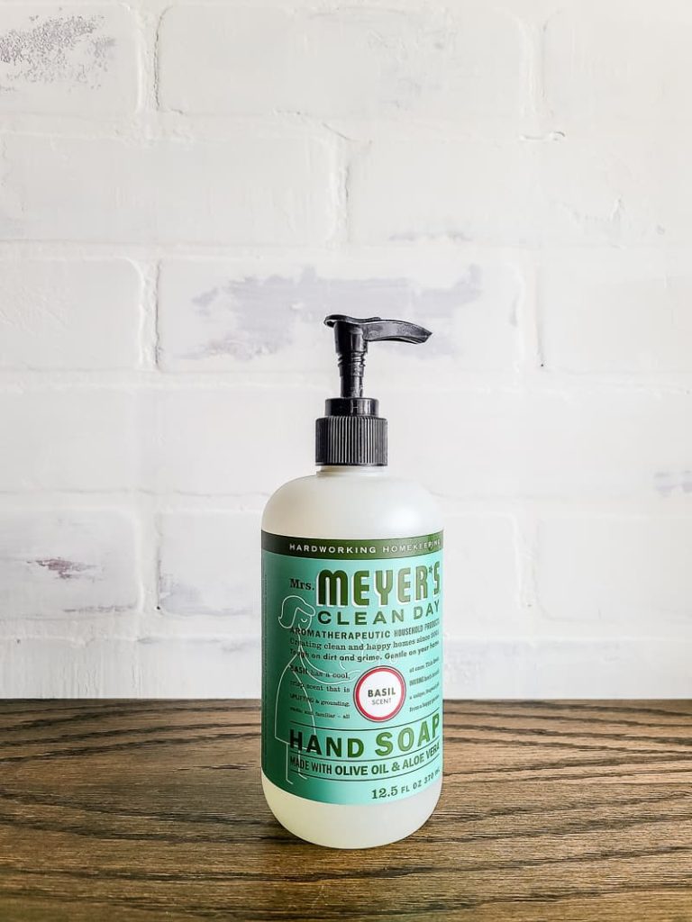 pump bottle of Mrs. Meyer's hand soap sitting on wooden counter top