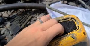 A person inserts a new clean air filter into a Wagner paint gun.