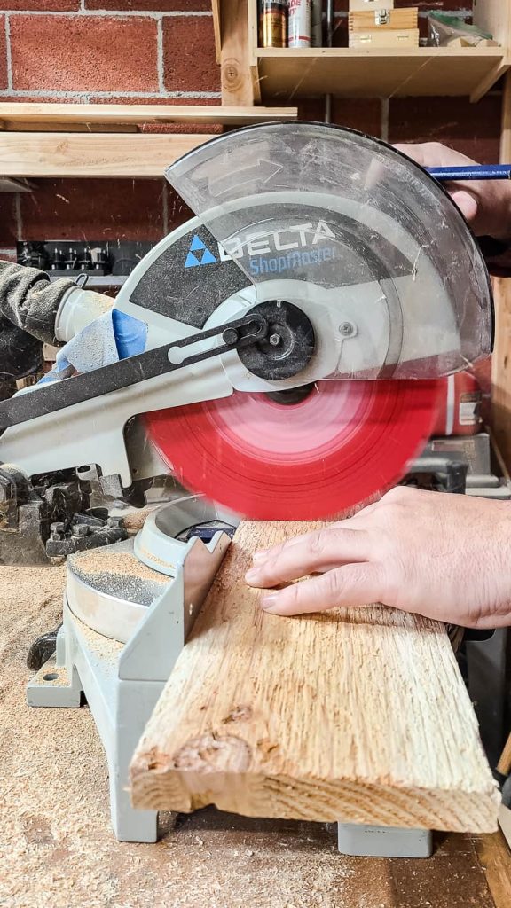 Photo of cutting the wood using a miter saw.