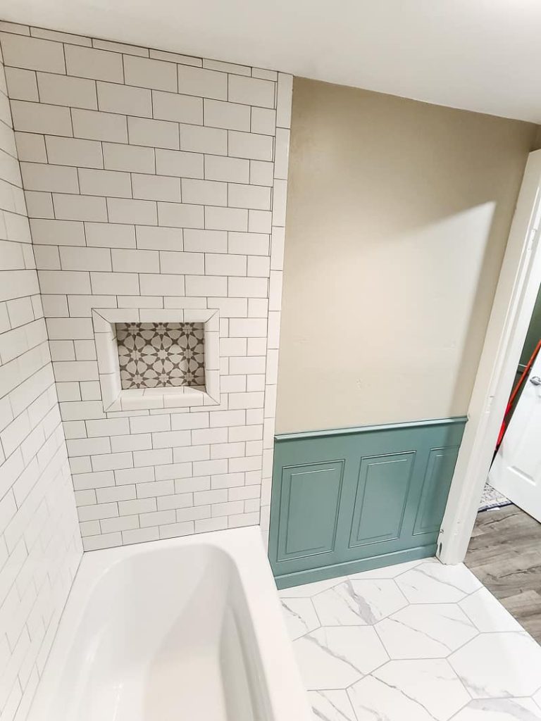 Overhead view of painted wainscoting panel in the bathroom next to the bathtub.