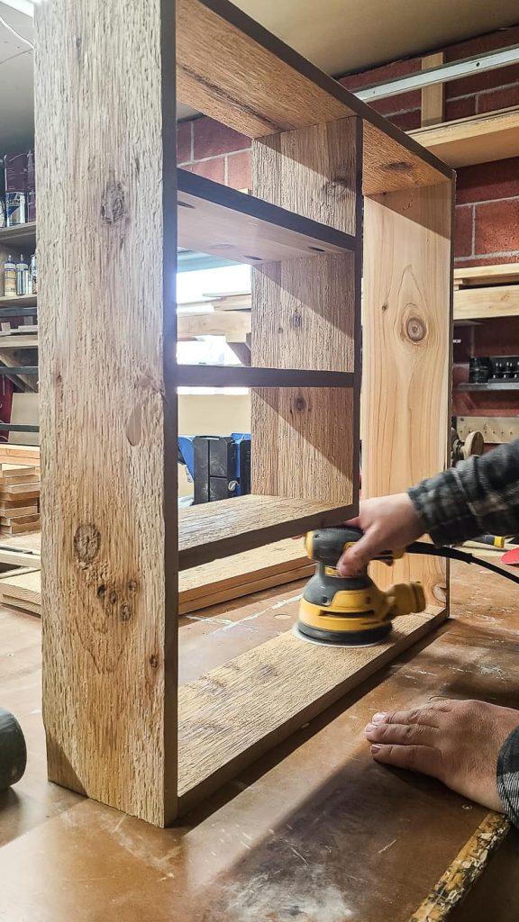Sanding the wood to make it smooth with orbital sander