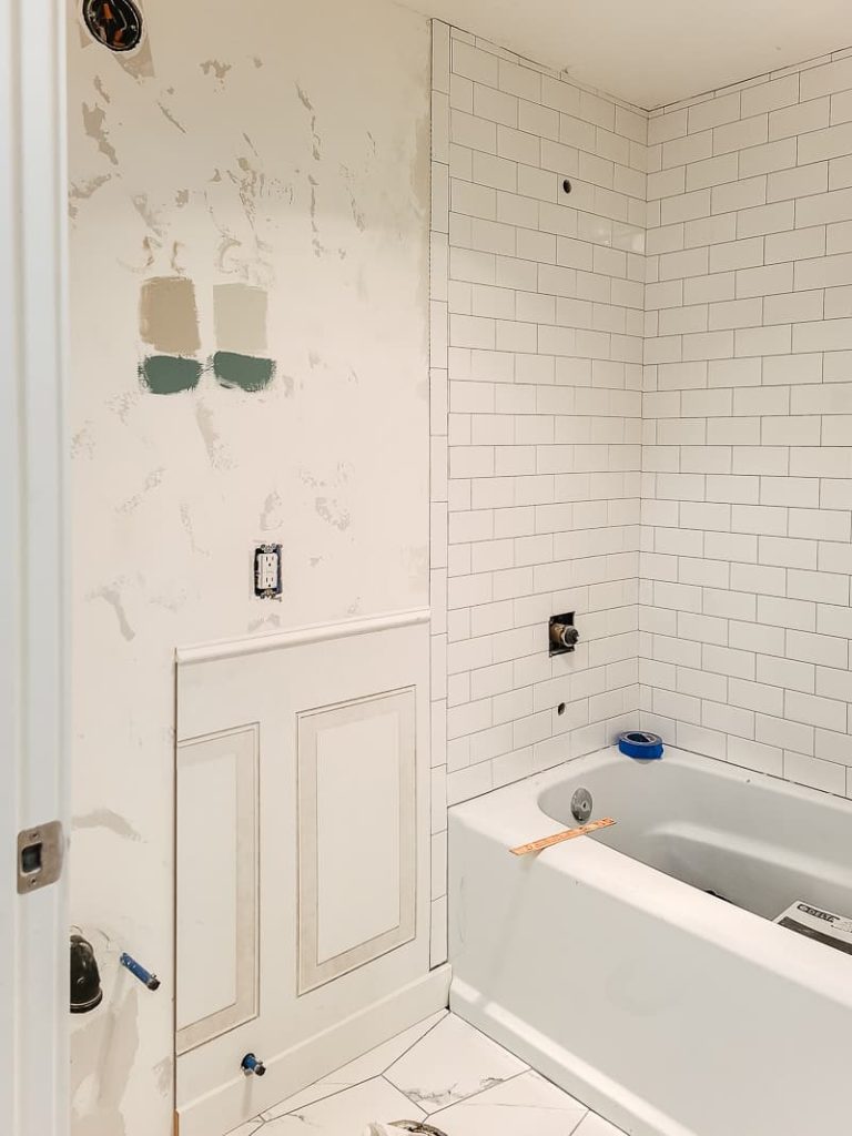 Wainscoting panel installed on the wall next tot the bathtub.