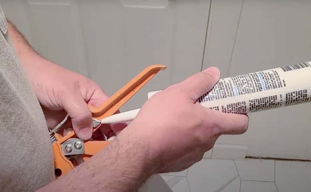 To puncture the seal, simply insert the puncture stick (on the side of the gun) through the tip of the tube. Rotate the tube around the stick to make sure there’s adequate room for the caulk to come out. Wipe the stick clean with a rag.
