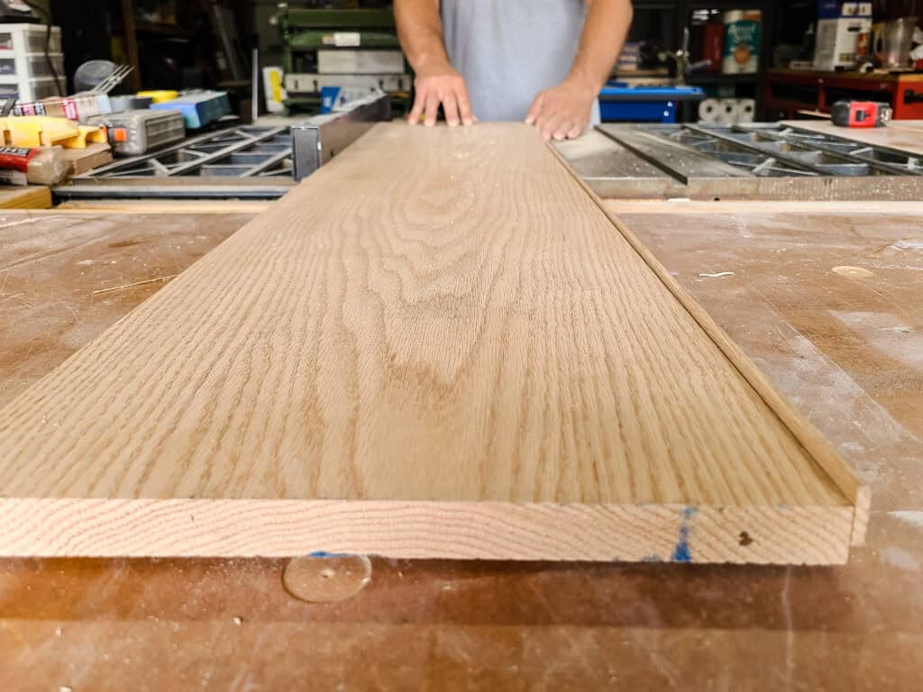 Cutting factory edge off of the board with a table saw for a wood towel rack