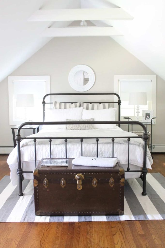 I love this farmhouse style master bedroom painted with Behr sculptor clay from The Picket Fence Projects.