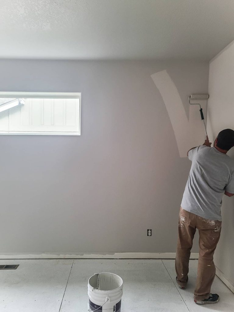 Paint colors always darken as they dry. Here's Logan rolling the 2nd coat of behr mineral paint on walls. 