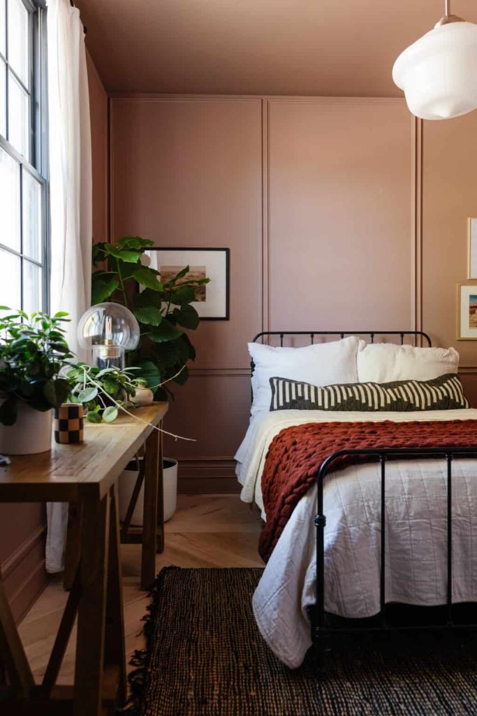 Sherwin Williams' color of the year for 2023 is Redend Point, a blush terracotta color that is beautiful and looks a bit like muted terracotta. Featured here on the walls of this bedroom from The Vintage Revivals. 