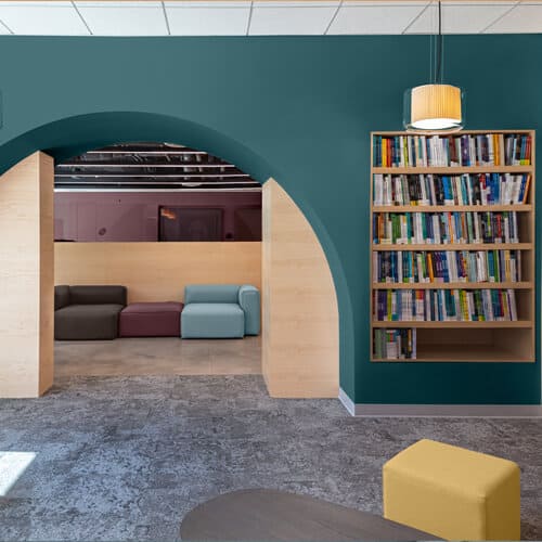 Glidden and PPG's color of the year is a blue green color that looks a bit like aqua or turquoise, called VIning Ivy. It loosk great here when used in this modern office or library space. 