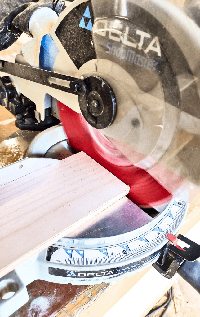 Using miter saw to cut the wood for DIY trash can for kitchen
