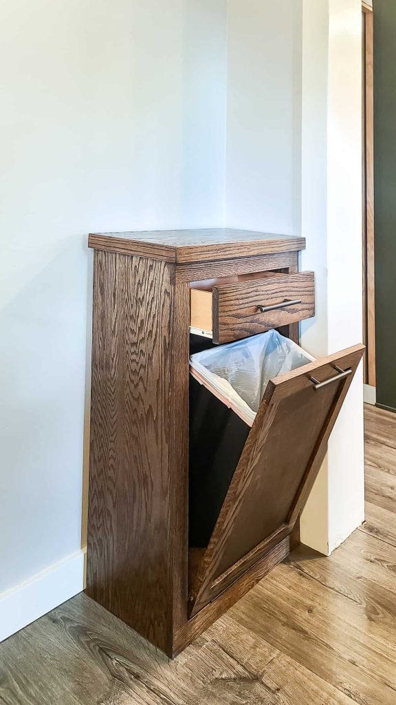 finish product of a DIY trash can cabinet with open doors