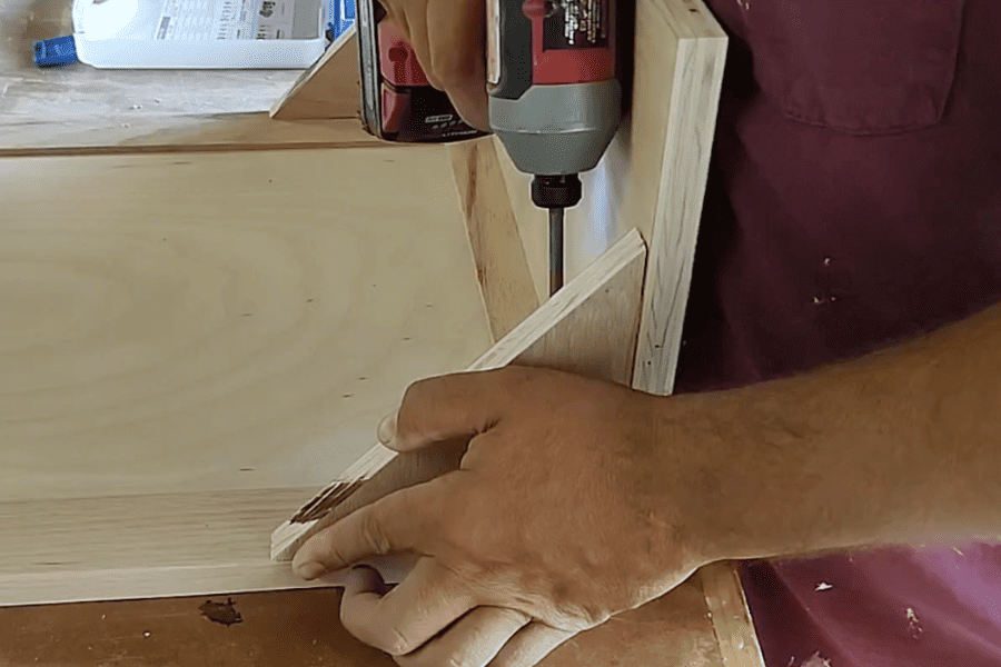 Attached the tilt bin to the wooden cabinet to hold a trash can with a tilt out platform

