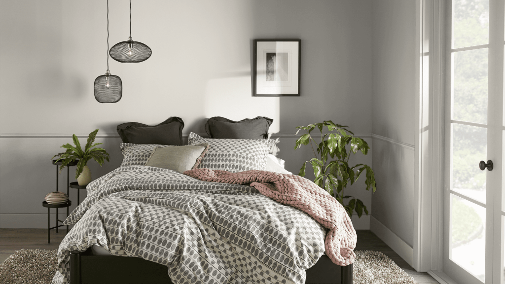 This gorgeous cozy bedroom with windowed doors letting in a lot of natural looks great with the walls in Behr mineral paint color.