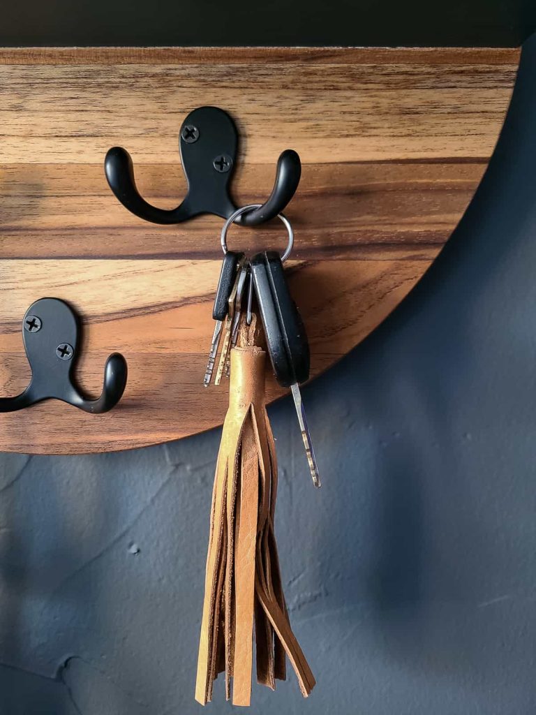 Hardware with hooks finished in a black is a perfect way to hang keys and in a decorative fashion for a living room