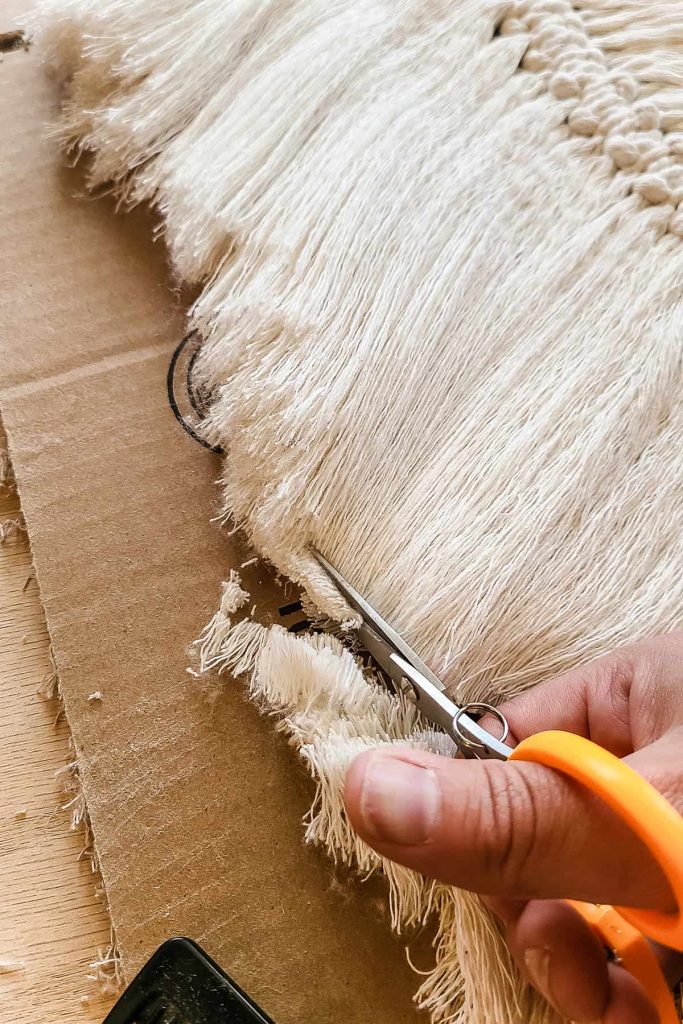 Close up image of scissors cutting the cord to make the feather shape.