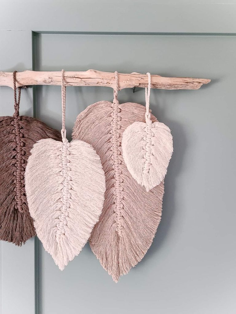 Close up of macrame feathers in different shades of pink