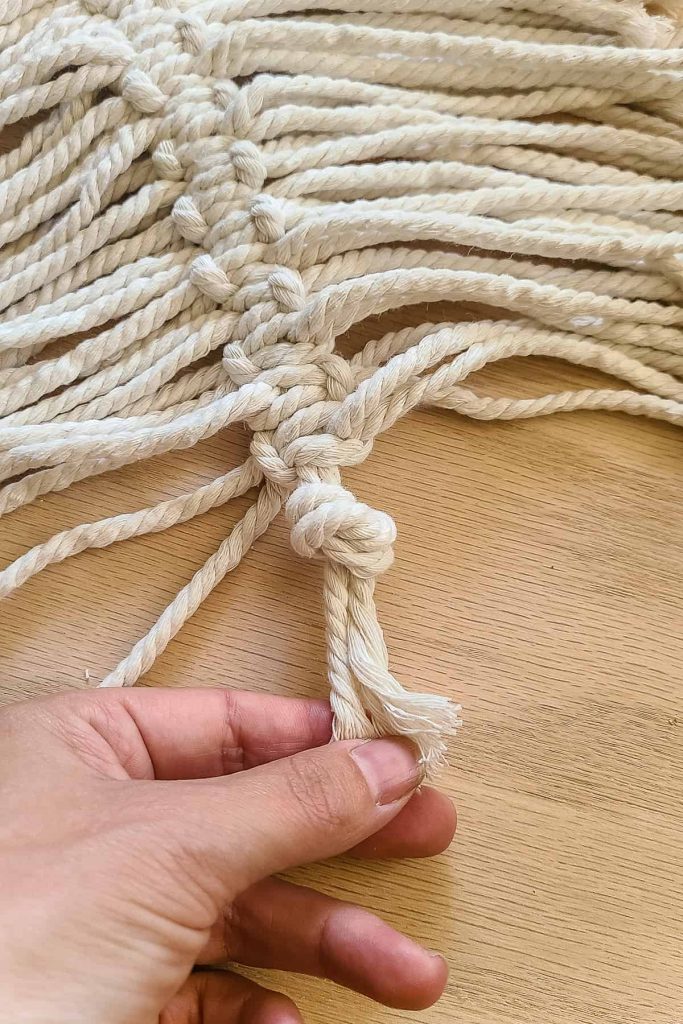 Close up of knot tied at the bottom to keep the cords from coming off the center cord.