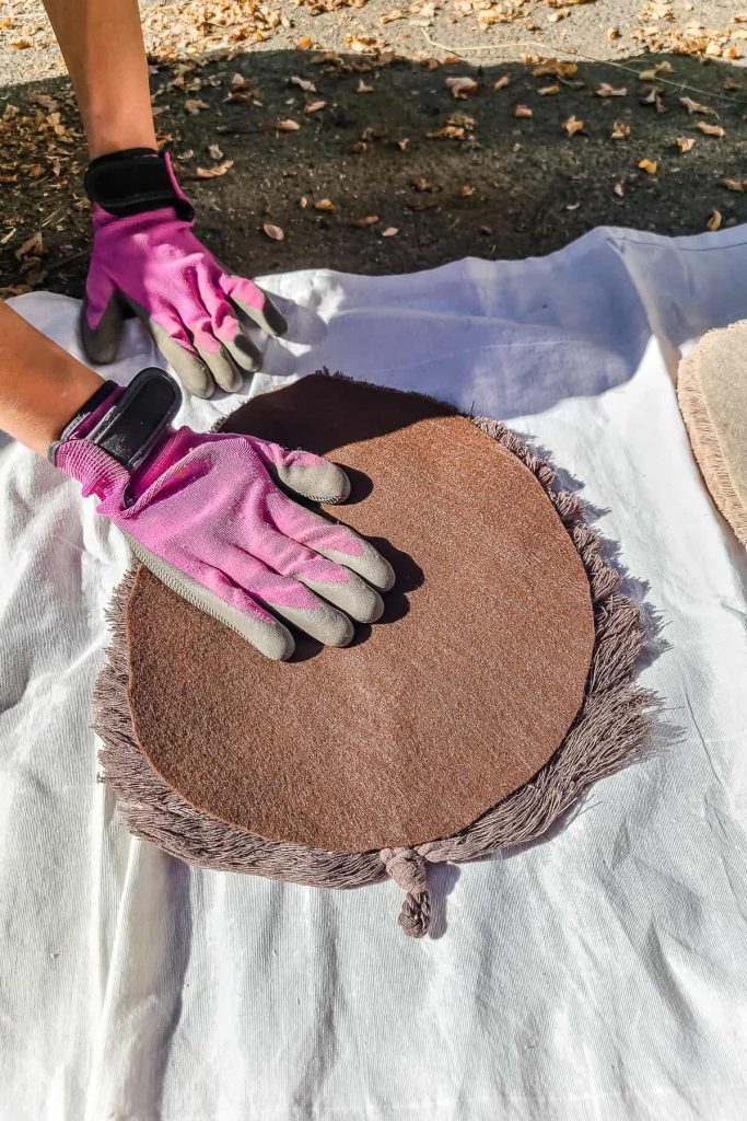 Placing felt feather shape to the back of a macrame feather.