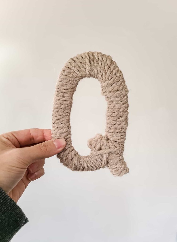 Wrapping cardboard letters with yarn is a cheap and easy way to label your christmas stockings