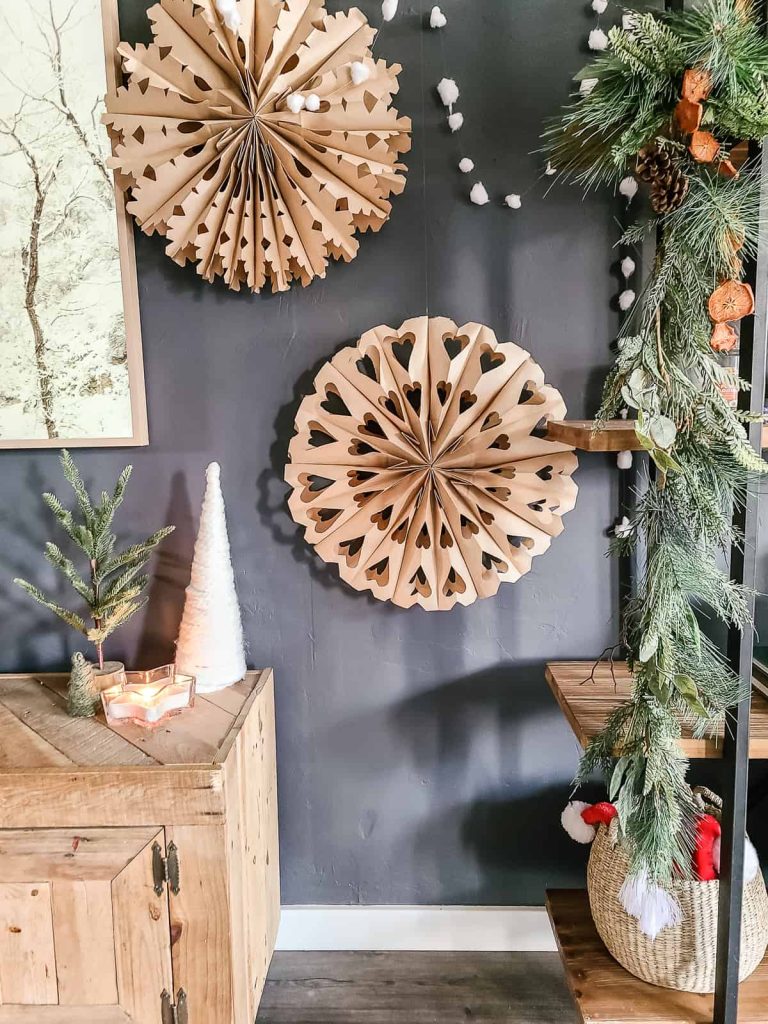 These paper bag snowflakes blend in perfectly with other garland and Christmas decor for any space