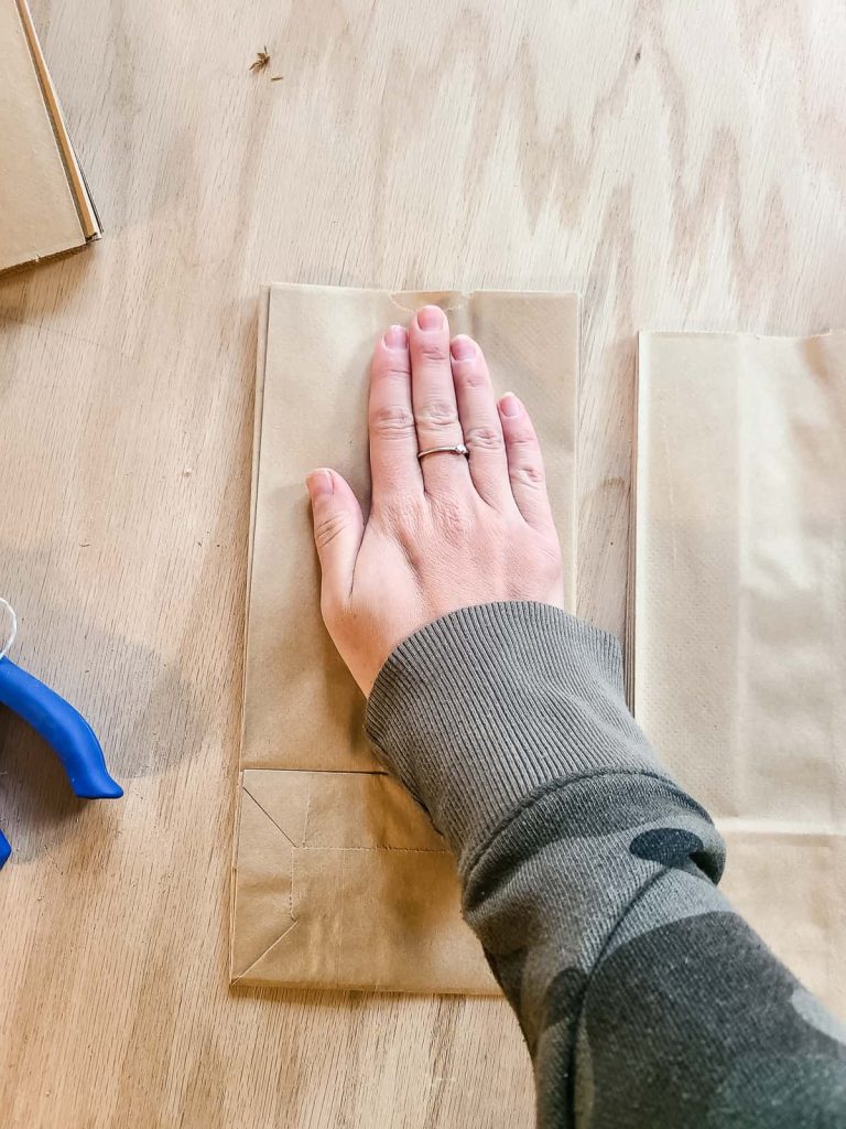 Use your hand or another flat weight to press the paper bags together to ensure a good bond between bags