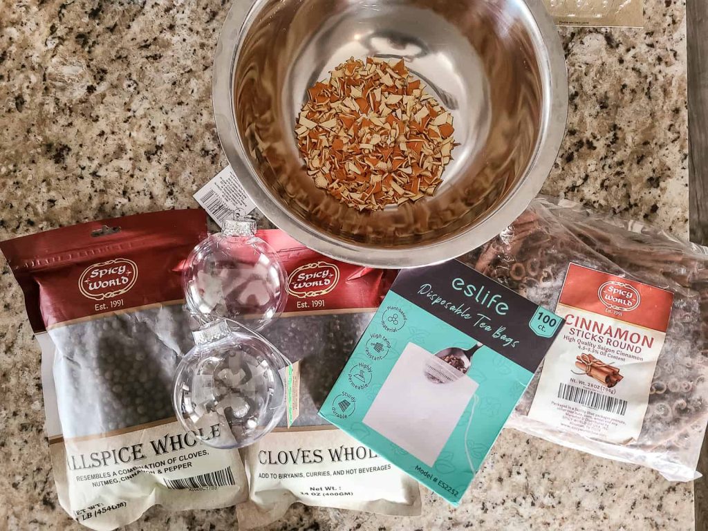 All of the ingredients for mulled wine spice mix ready to be prepared and put into clear Christmas ornaments 