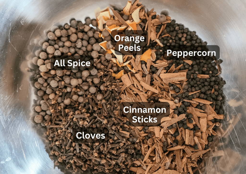 All the ingredients in a bowl for the homemade mulling spices before mixing together 