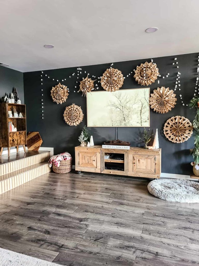 Living room winter decorations with paper snowflakes and cotton ball snowball garland on wall