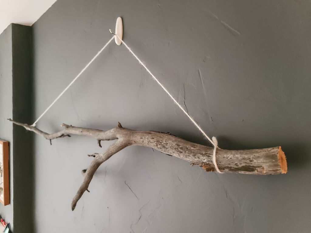 Image of a wood decor mounted on the wall using Command strips for a seamless and damage-free installation
