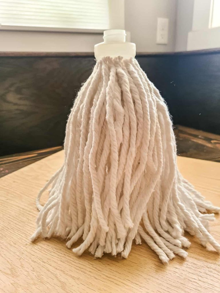 white mop strings glued to spray bottle for gnome beard