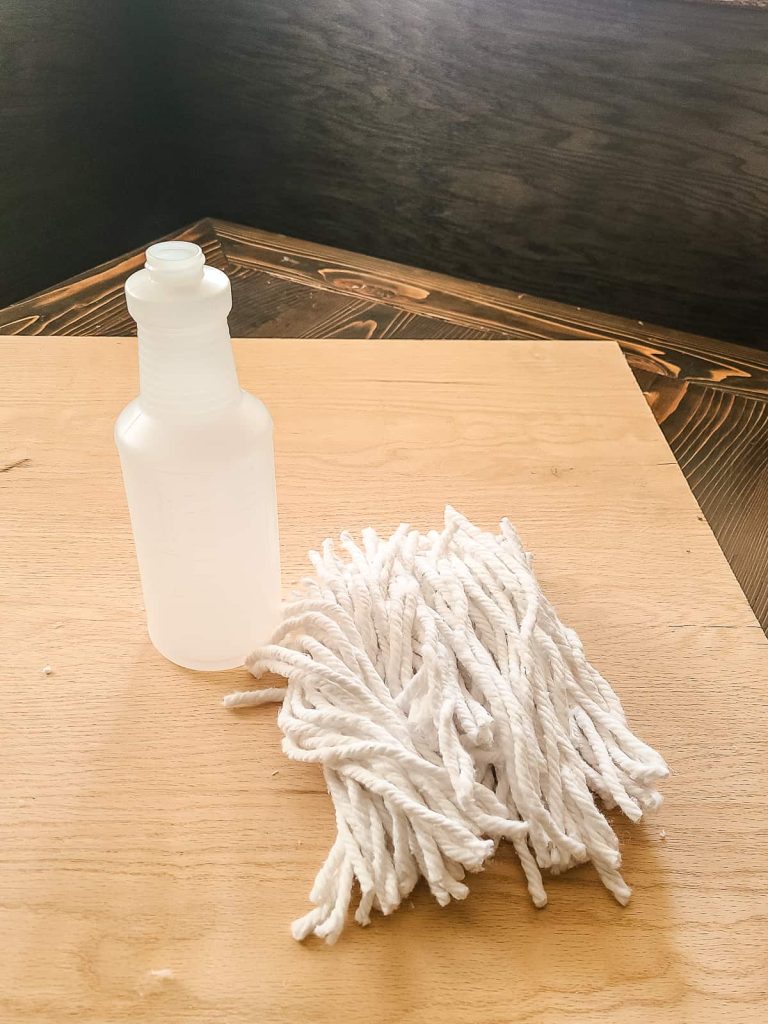 white mop strings and spray bottle