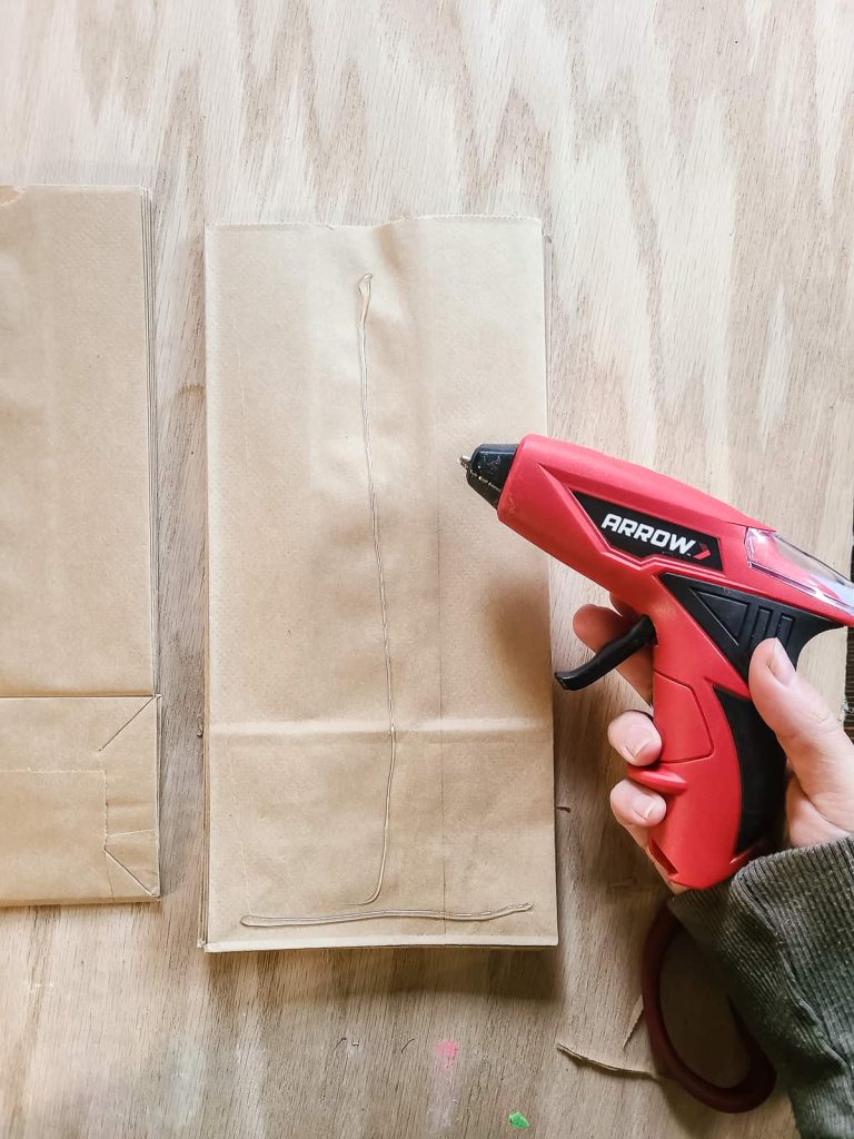 Gluing paper bag snowflakes together is easy with arrow's hot glue gun simply add a little glue and press