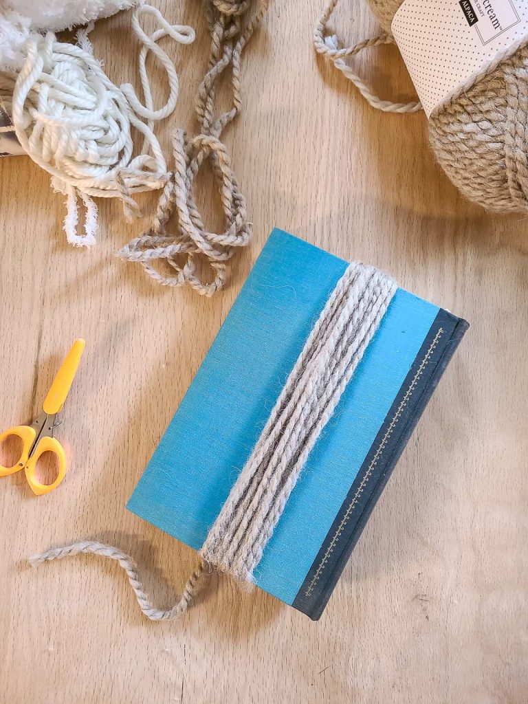 yarn wrapped around book to make a tassel