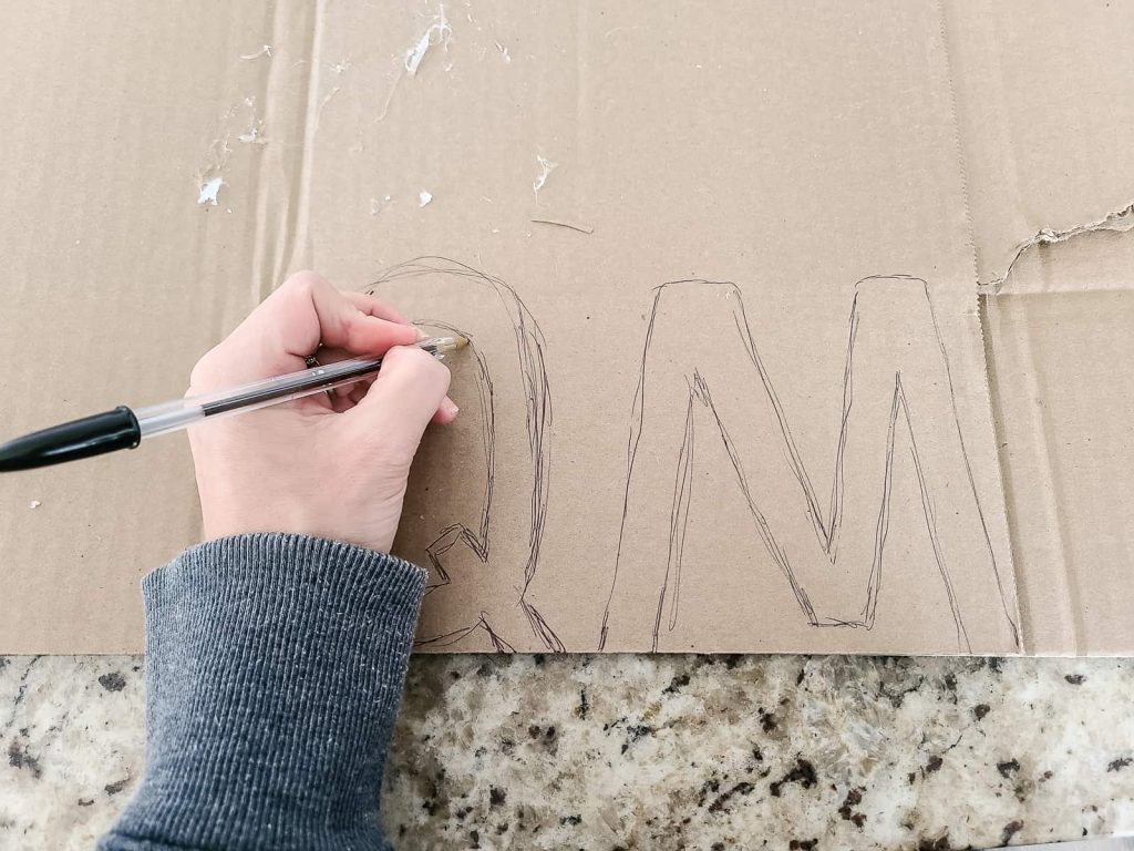 Start the letter stocking tags by drawing out your family's letters on cardboard with a pen