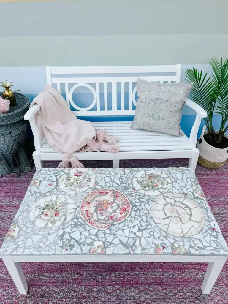 Cheap deck decorations can be maid with recycled items, like this broken china pieces used to make a coffee table top for the backyard deck