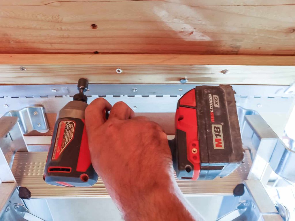 Using lag screws to plant and stabilize the frame to ensure it will not move when it is operated