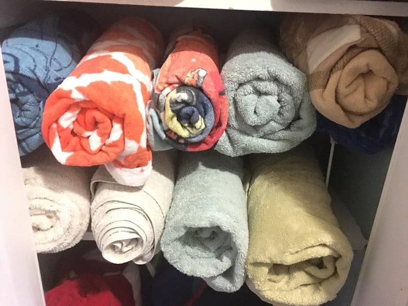 towels rolled and stored in linen closet idea for how to store blankets