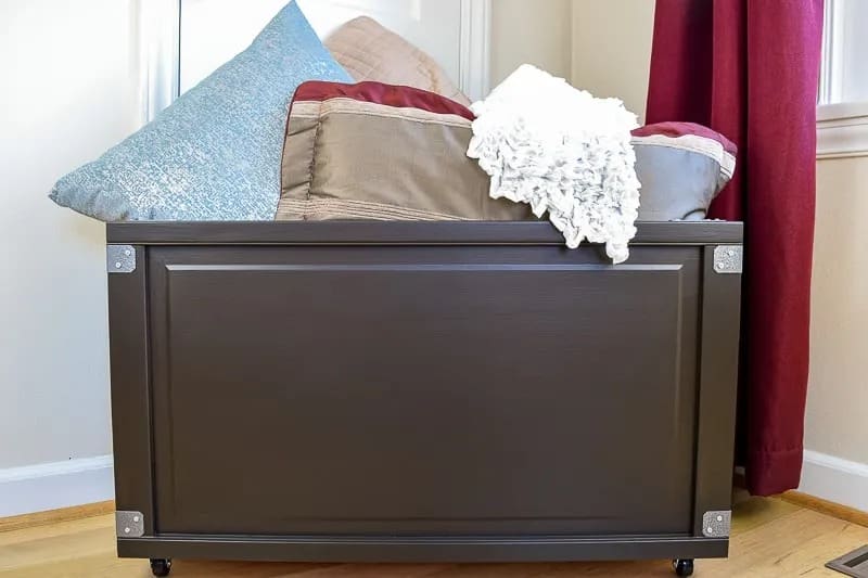 DIY storage box on wheels for blanket storage in the bedroom