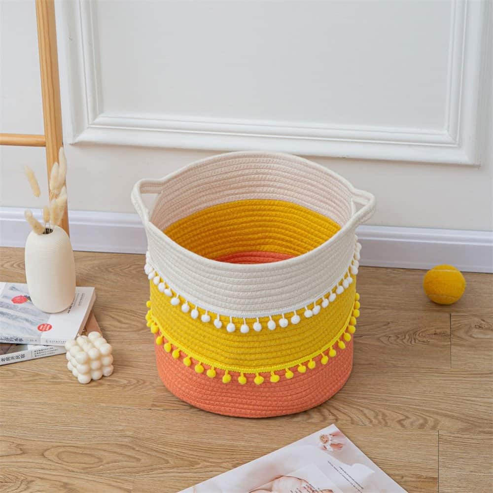 fabric storage basket in yellow and coral with white pom pom tassels