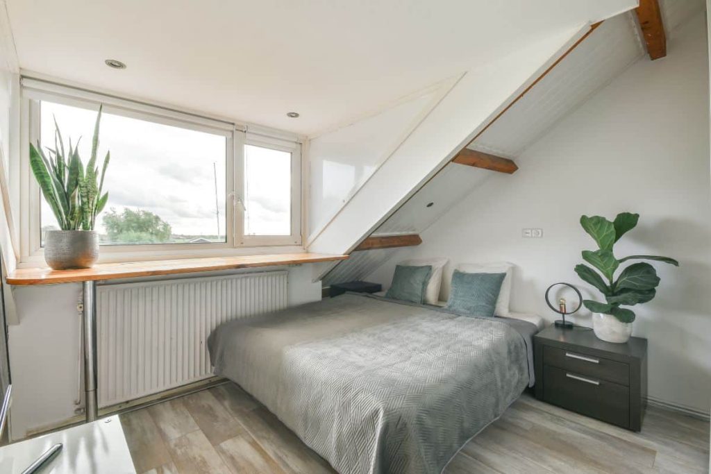 Keeping your bed in the corner, like this, can make your small bedroom look and feel a lot larger