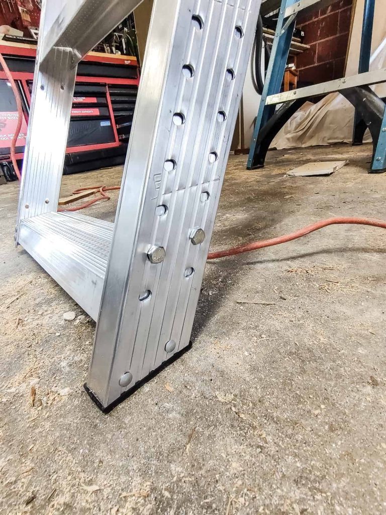 Attaching the foot to the base of the ladder to ensure it has a good grip and unfolds perfectly straight to the floor